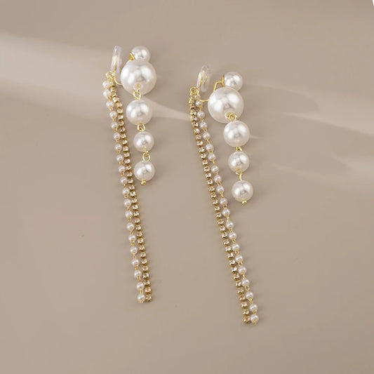 Detailed view of one Pearl Cascade Clip-On Earring, highlighting the lustrous faux pearls and sparkling zircon stones.