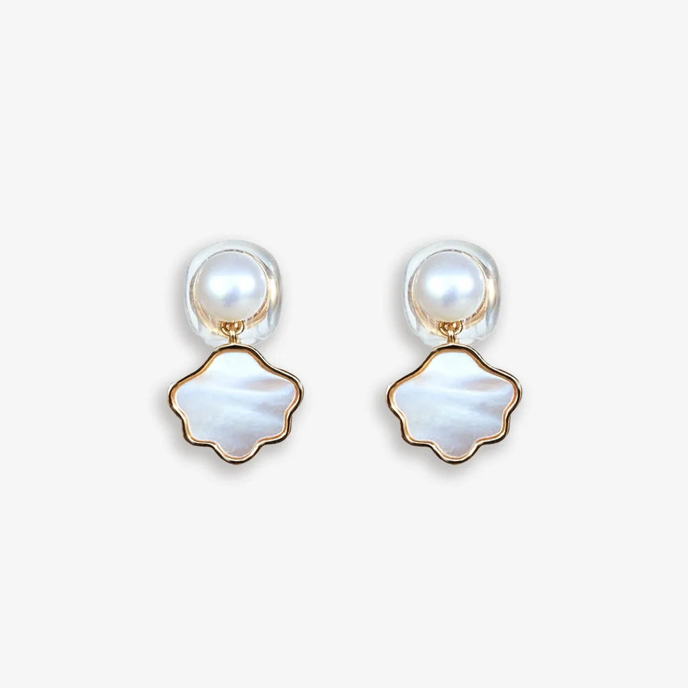 Pair of Pearl and Shell Clip-On Earrings displayed on a soft white surface, capturing the refined design and luxurious materials.