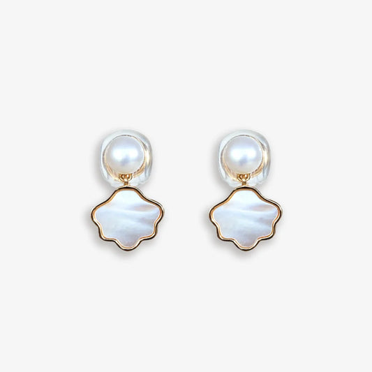 Pair of Pearl and Shell Clip-On Earrings displayed on a soft white surface, capturing the refined design and luxurious materials.