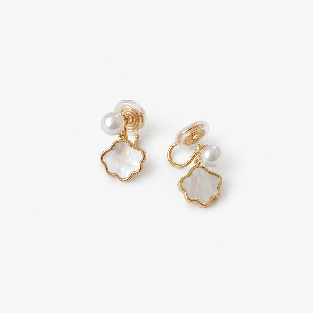 Genuine Pearl and Shell Clip On Earrings in gold with mother of pearl flower charms, top view 