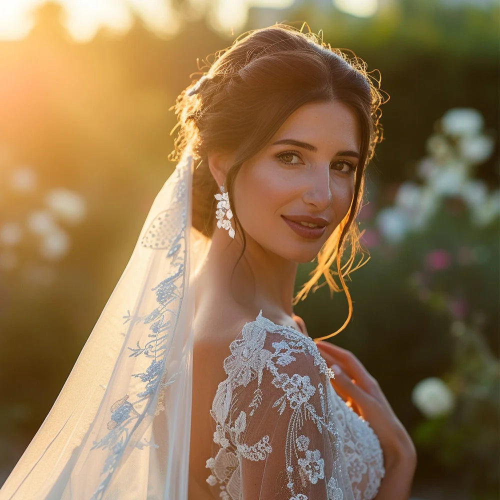 Model wearing Petal Pearl Cascade Clip-On Earrings, showcasing elegance for weddings.