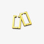 A pair of gold geometric clip-on earrings with a modern open-frame design, displayed on a clean white background.