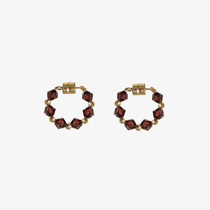 These magnetic earrings are adorned with beautiful red bicone crystals for a striking look.