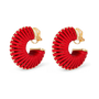A pair of gold hoop earrings with textured red pleated petals, shown on a clean white background.