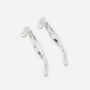 A pair of silver drop earrings with a polished, curved ribbon-like design, shown on a light gray background.