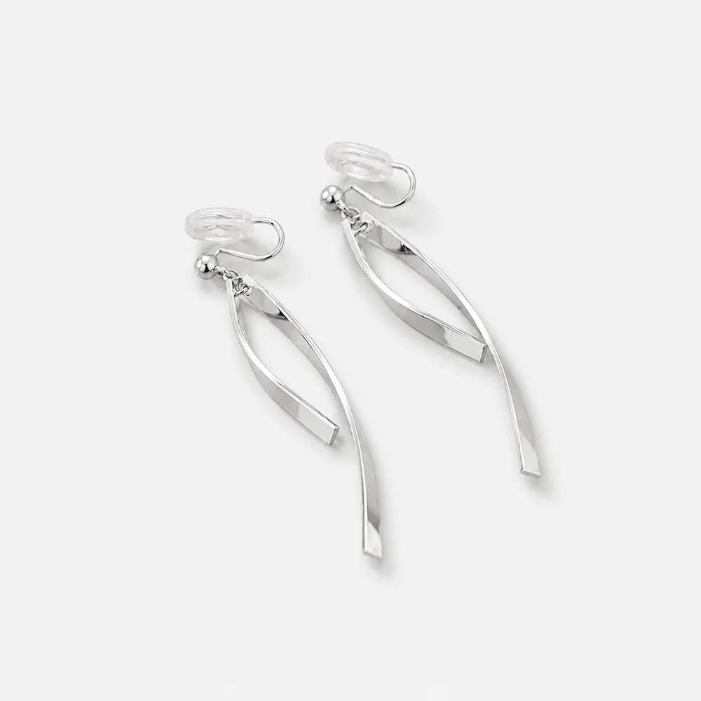 A pair of silver-toned dangle earrings with a modern, flowing ribbon-like design, shown on a clean light gray background.