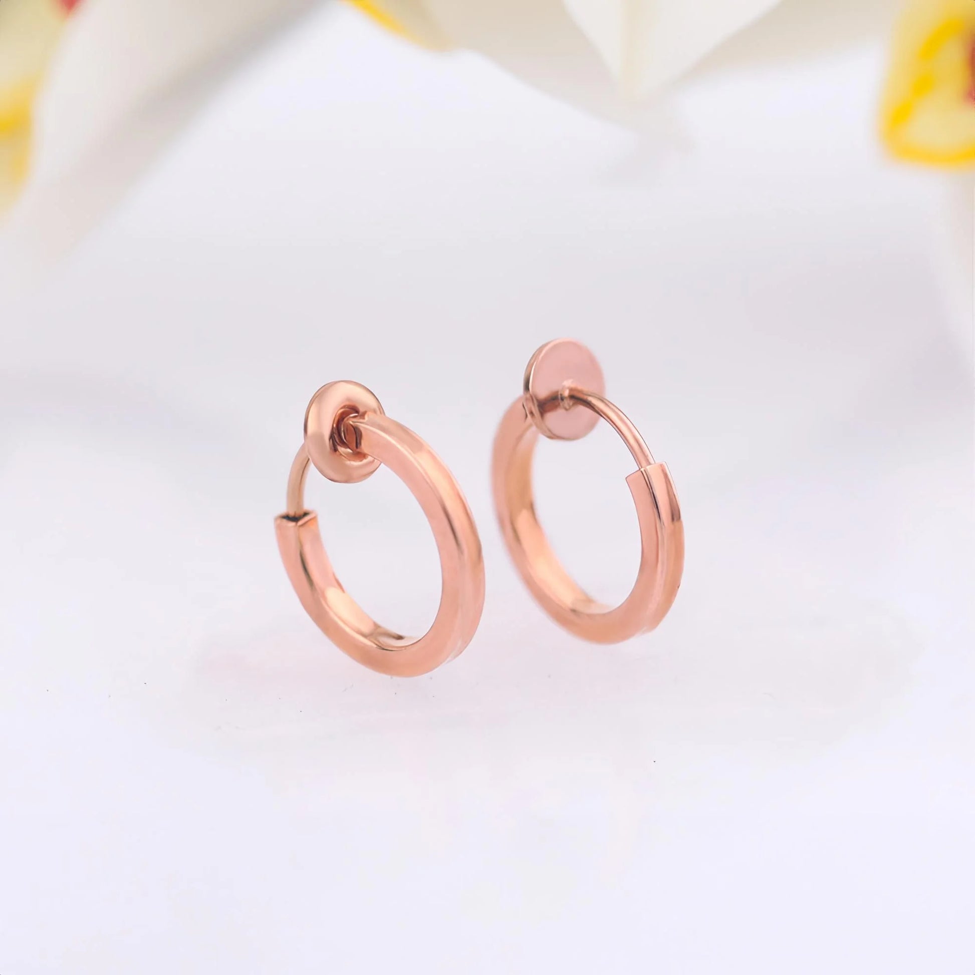 Lightweight and stylish Rose Gold Mini Clip-On Hoop Earrings for women, available in 13mm and 15mm diameter options.