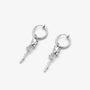A pair of silver hoop earrings with dangling rose with vine shaped charms, shown on a light gray background.