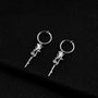 Silver rose vine clip-on hoop earrings displayed on black background, showing detailed floral design and polished metal finish