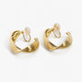 Gold rotating spiral clip-on hoop earrings with moonstone tops displayed in white background