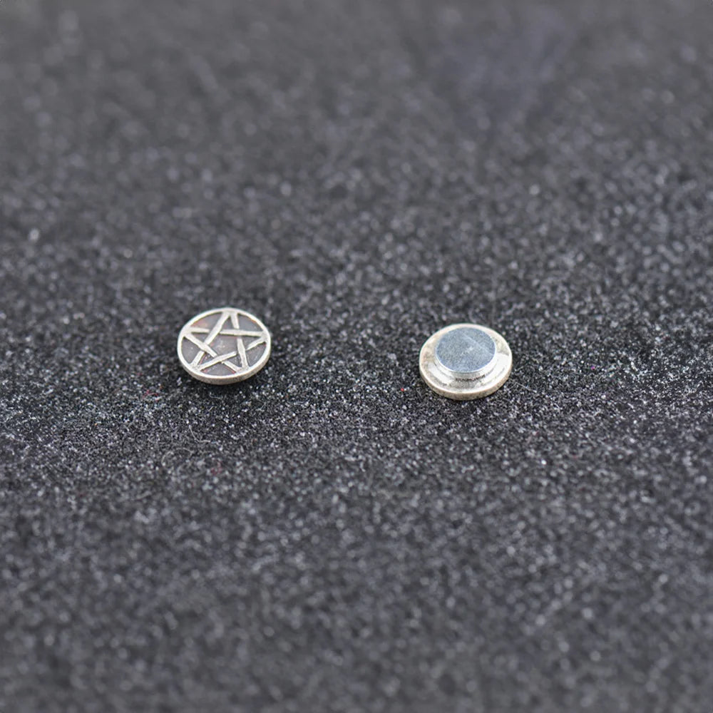 A pair of Sterling Silver Aged Star Magnetic Stud Earrings, showing the magnetic back and antique star design.