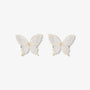 Pair of Silhouette Butterfly Wings Clip-On Earrings displayed on a jewelry stand, highlighting the intricate butterfly wing design.