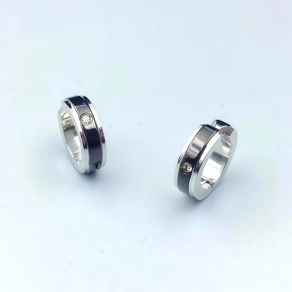 Close-up of fake diamond earrings for men with black stripe
