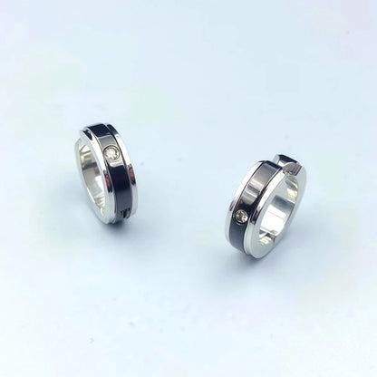 Close-up of fake diamond earrings for men with black stripe
