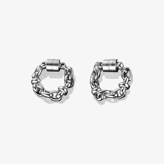 A pair of silver magnetic hoop earrings made from titanium steel.