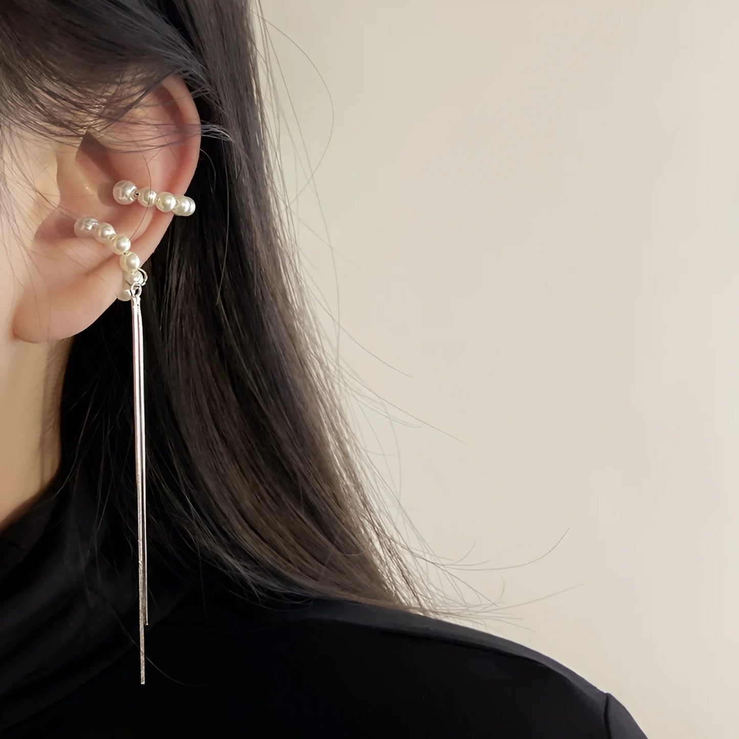 Model showcasing the clip on wedding earrings, featuring a combination of pearls and tassels.