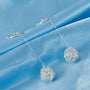 Close-up of Silver Filigree Ball Drop Clip-On Earrings on a white background.