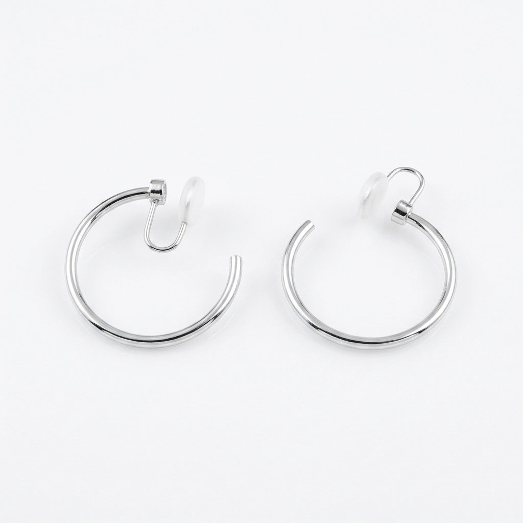 A pair of rotating silver hoop earrings with u-type closures, shown on a clean white background.