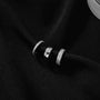 Trio Silver Ear Cuff Stacking Set displayed on black fabric, showing three textured and polished silver cuffs stacked together