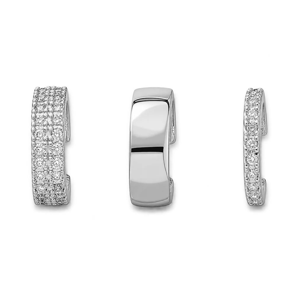 Three views of a silver-toned huggie hoop earring set with pavé diamonds, shown on a plain white background.