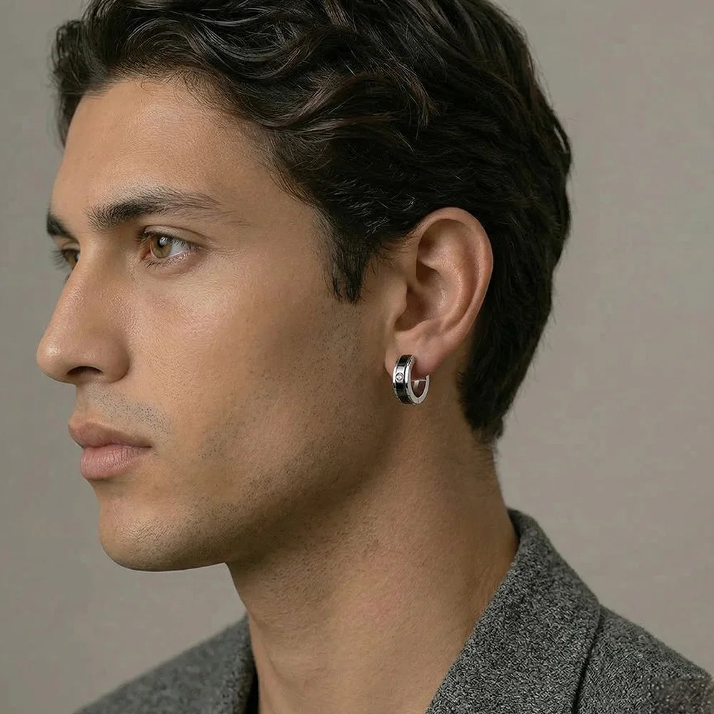 A latino male wears clips earrings with bold silver finish and CZ sparkle