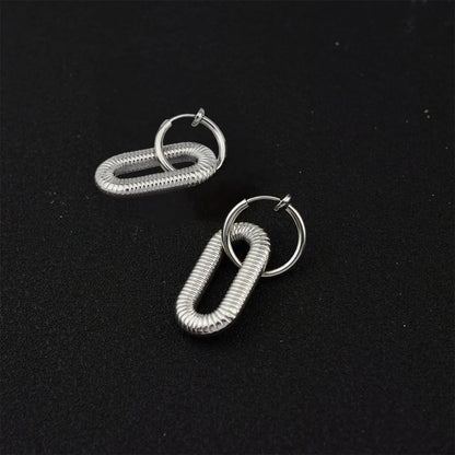 Detailed view of one Slivery Spiral Clip-On Dangle Hoop Earring, highlighting the unique spiral design and sleek silver finish.