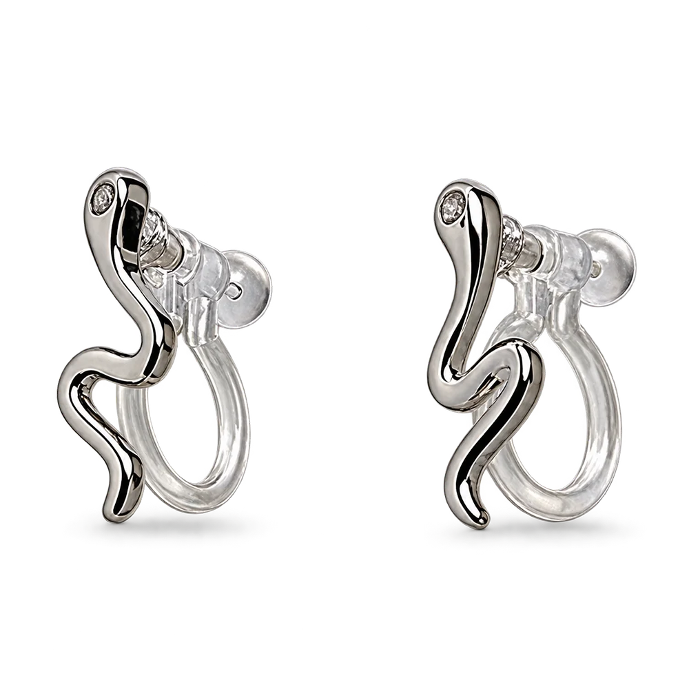 A pair of silver huggie hoop earrings with a wavy, snake-like curved design and a small clear gemstone at the top, shown on a plain white background.