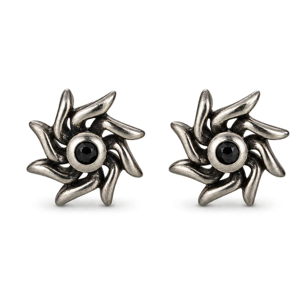 A pair of oxidized silver turbine-shaped stud earrings with a central black gemstone, shown on a clean white background.