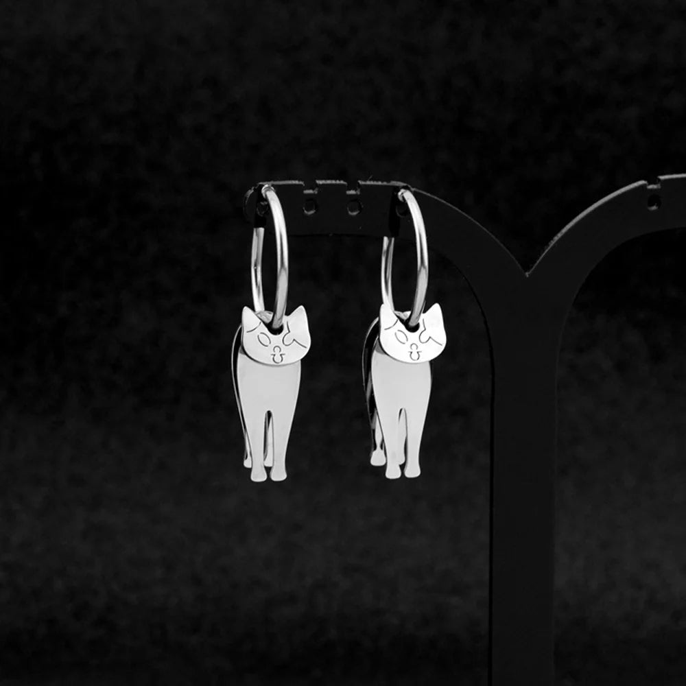 Stainless steel articulated cat clip-on earrings with hoop design, front view on black background