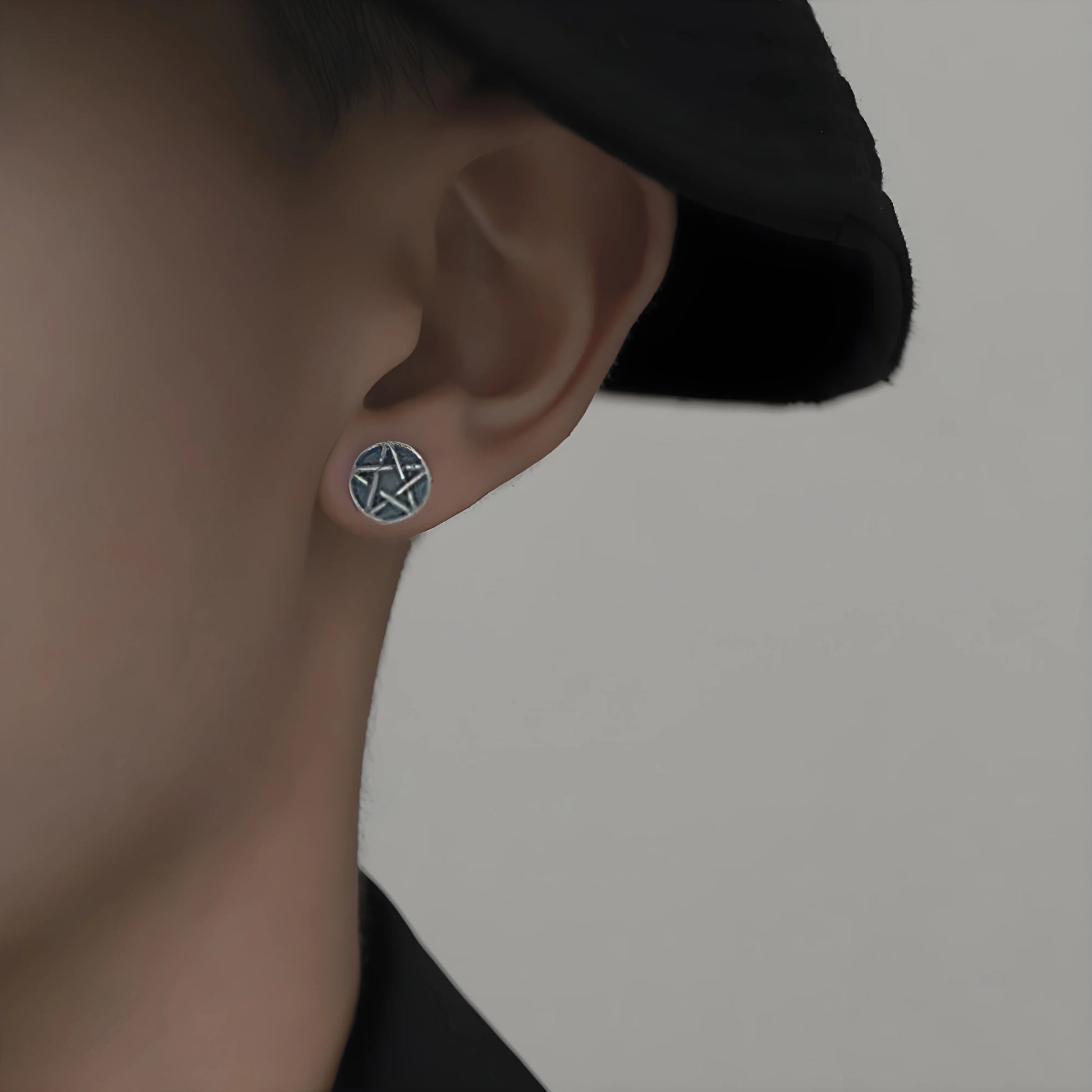 Model wearing the Sterling Silver Aged Star Magnetic Stud Earrings, displaying how they enhance any look.