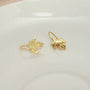 Sterling silver maple leaf clip earrings in gold displayed on white ceramic dish, front view