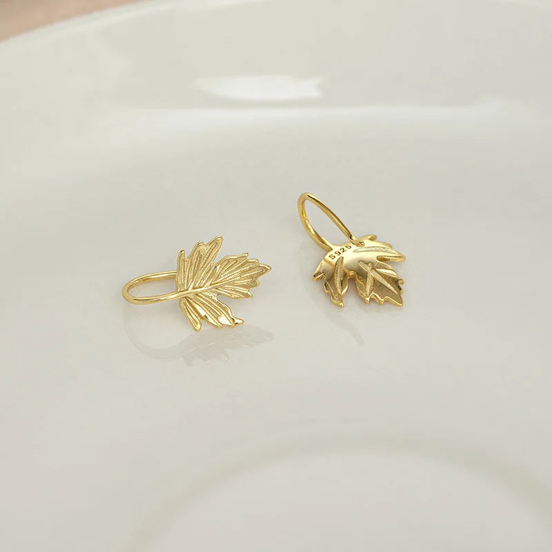 Close up of the intricate maple leaf design on the gold cuff earrings.