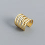 Gold sterling silver multi-band ear cuff shown at an angle on white background, displaying layered curved design