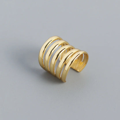 Sterling silver ear cuff for men and women, plated with 14k gold, showcasing a sleek multi-band design.