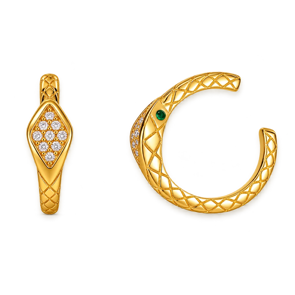 A pair of gold snake-themed jewelry pieces on a plain white background, featuring a diamond cluster on one piece and a textured snake head with a green gemstone on the other.