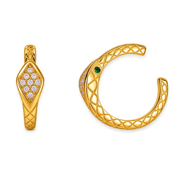 A pair of gold snake-themed jewelry pieces on a plain white background, featuring a diamond cluster on one piece and a textured snake head with a green gemstone on the other.