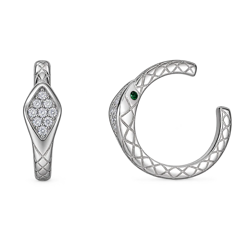 A silver-toned snake-themed jewelry set on a white background, featuring a snake-shaped earring with a cluster of clear stones and a matching open cuff with a small green eye accent.