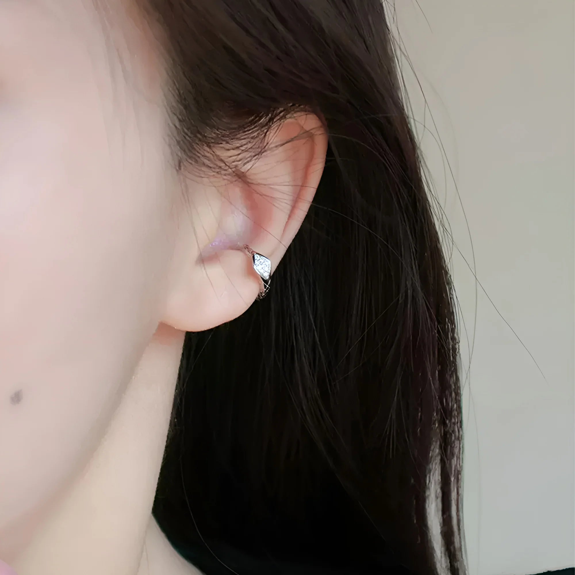 Sterling Silver Ouroboros Ear Cuff in White Gold side view on model with black hair