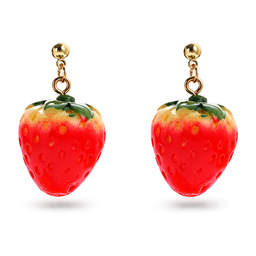 A pair of strawberry-shaped dangling earrings with glossy red bodies, green leafy tops, and gold-tone posts and hooks, shown on a plain white background.