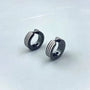 Muscular-style fake earrings with a striped industrial design