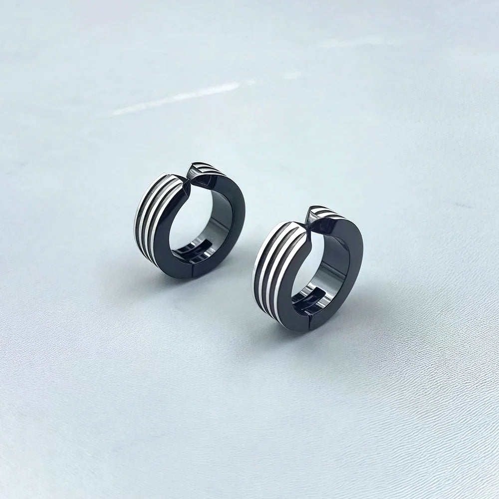 Muscular-style fake earrings with a striped industrial design