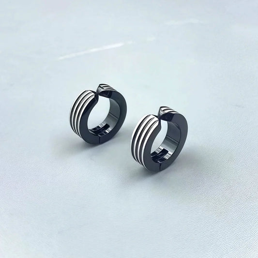 Muscular-style fake earrings with a striped industrial design