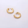 Diamond clip-on gold hoop earrings displayed on white background, showing elegant pair with cubic zirconia stones