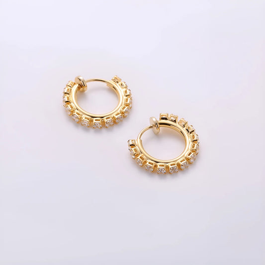 Small gold mini hoop earrings with a sliding spring-hoop clip-on mechanism, perfect for all-day wear.