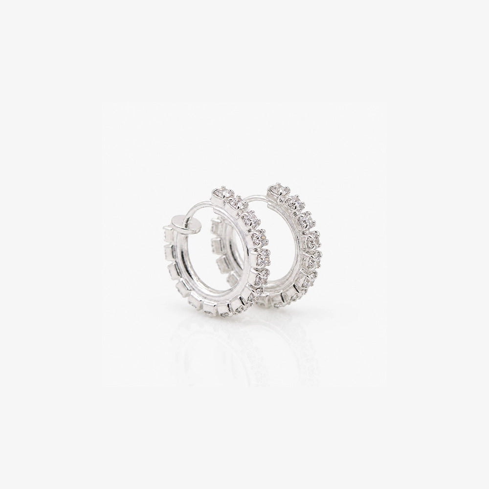 Diamond clip-on silver hoop earrings top view on white background showcasing sparkly round design