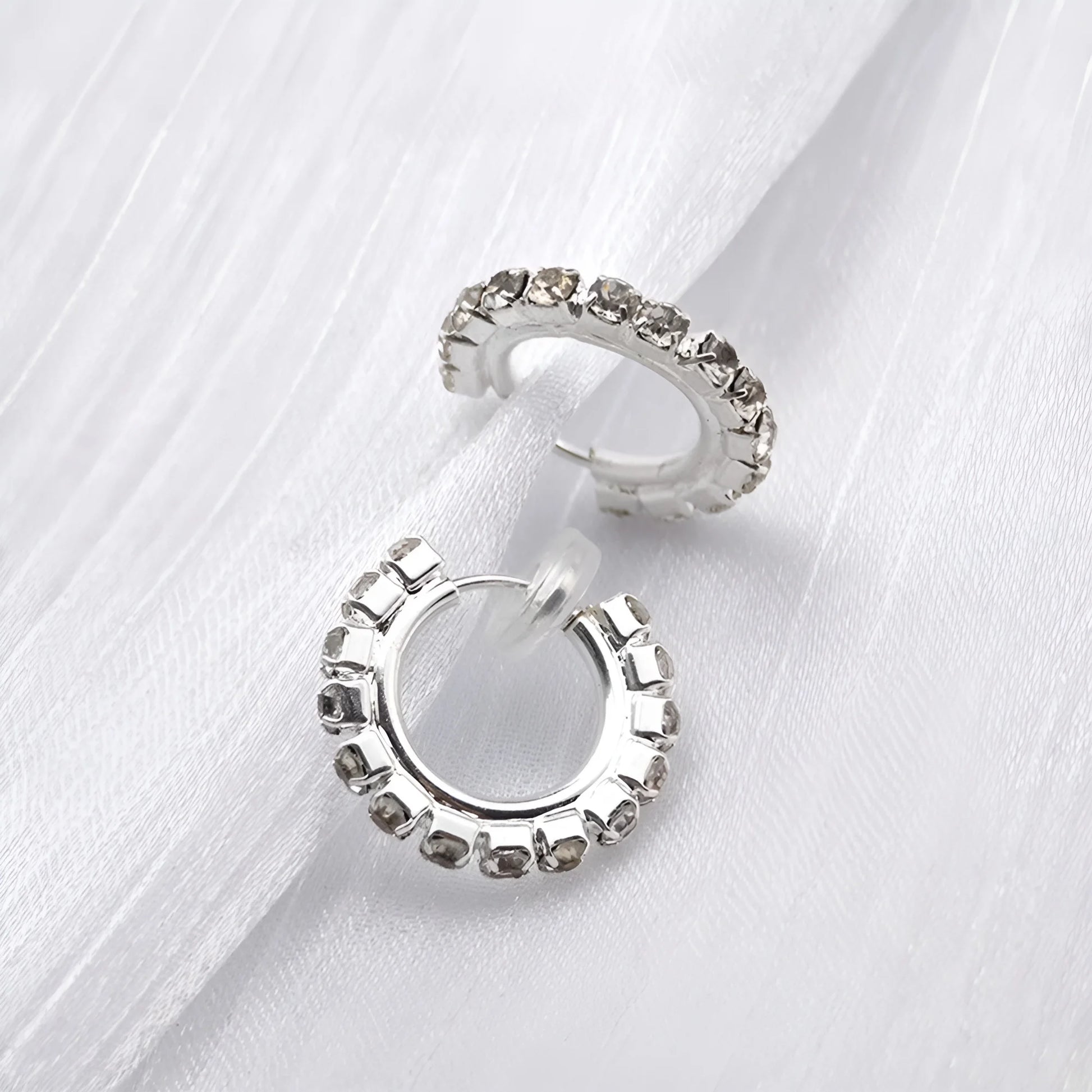 Lightweight silver hoop clip-on earrings with sparkling synthetic diamonds, 18mm diameter.