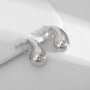 Silver teardrop clip-on earrings displayed at angle on white background showing polished finish and closure detail