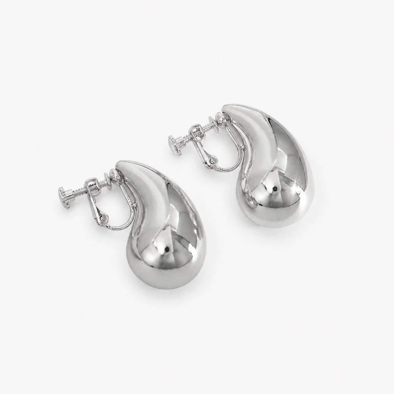 Silver teardrop clip-on earrings displayed at angle on white background showing polished finish and closure detail