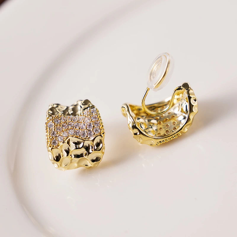 Detailed shot of the clip-on closure of Textured Gold & Pavé Clip-On Stud Earrings, perfect for non-pierced ears.