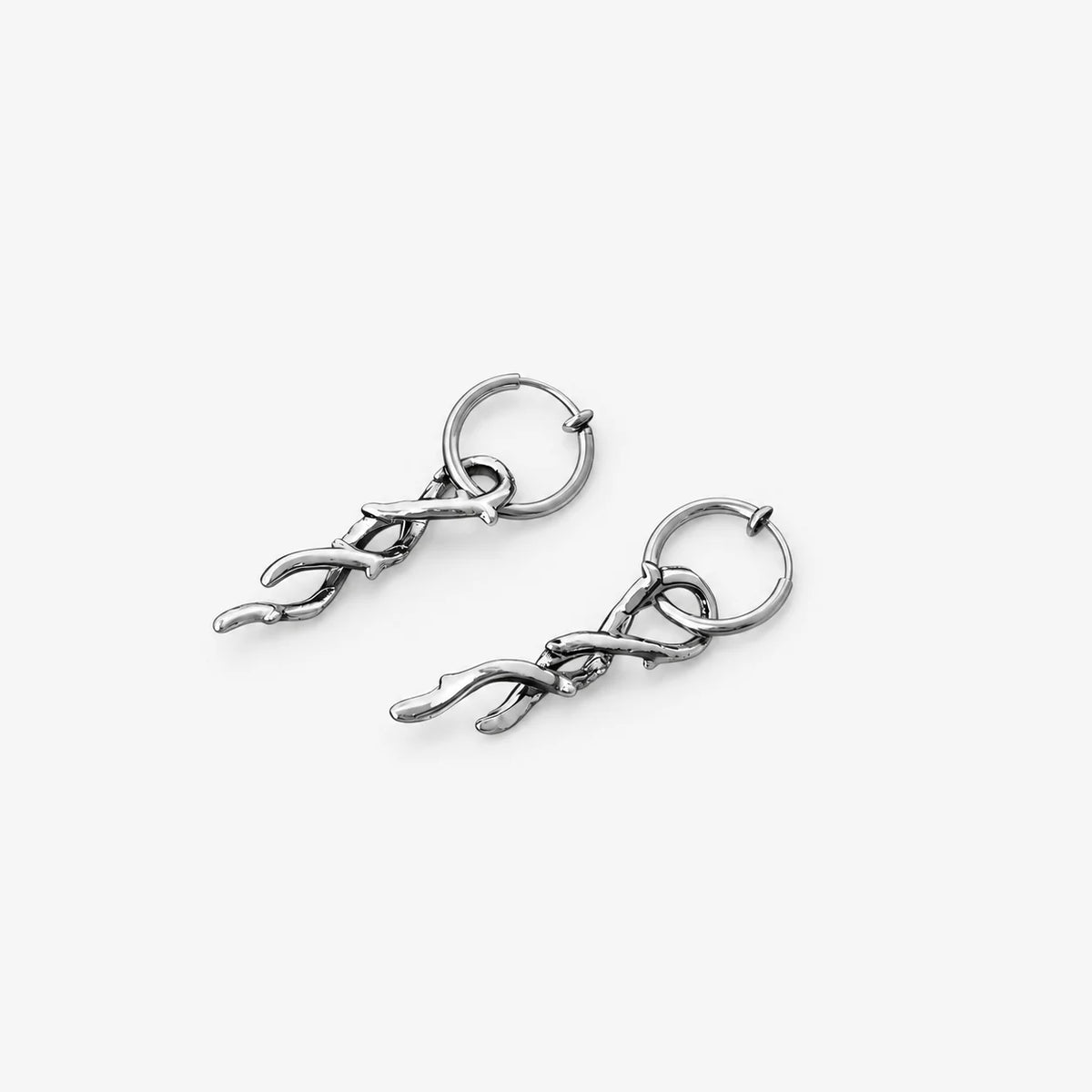 Silver thorn vine clip-on hoop earrings displayed at angle on white background